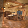 Natural roots flare from bottom of log character posts in dining room